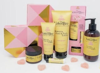 A displayed assortment of The Naked Bee products; lotion, lip balm and more. 